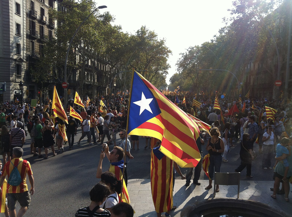 Catalan flags wave against the backdrop of Barcelona's bustling streets, as the quest for independence continues to shape the region's political landscape.
(Photo Credit: Kippelboy, CC BY-SA 3.0 , via Wikimedia Commons)
